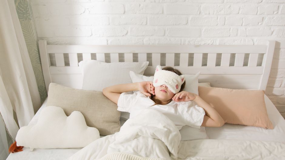 person sleeping peacefully in a dark bedroom